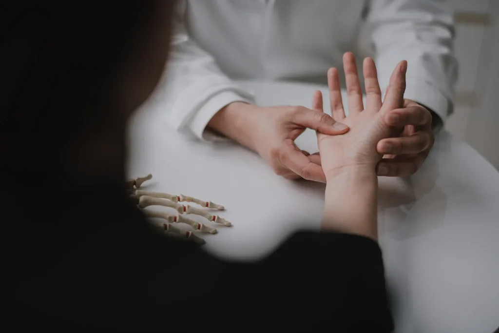Doctor looking at numb fingers