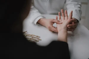 Doctor looking at numb fingers